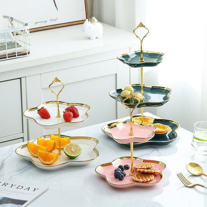 Elegant ceramic tiered fruit and snack stand in white, pink, and green for dessert or tea table