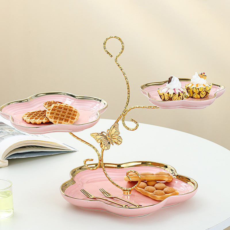 Elegant pink ceramic three-tier dessert stand for cakes, fruits, and sweets
