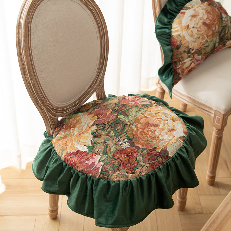 Close-up of vintage floral chair cushion with green ruffled edge