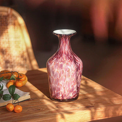 Vintage purple glass vase in warm sunlight home scene